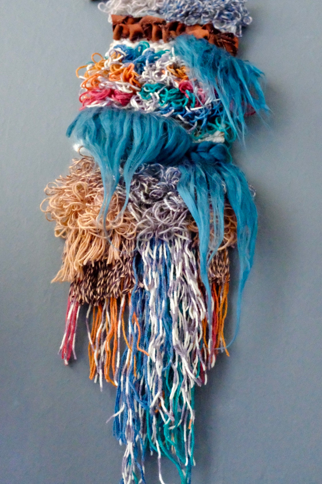 a view of the trollfall mini wall hanging showcasing the fiber waterfalls and the loops in all their glory!