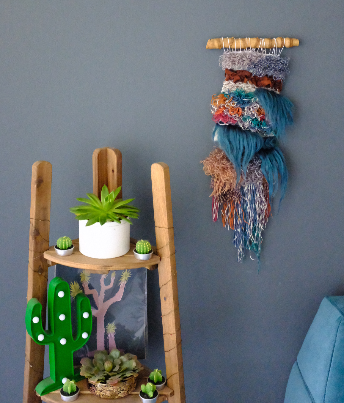 the trollfall mini wall hanging displayed near some desert inspired home decor